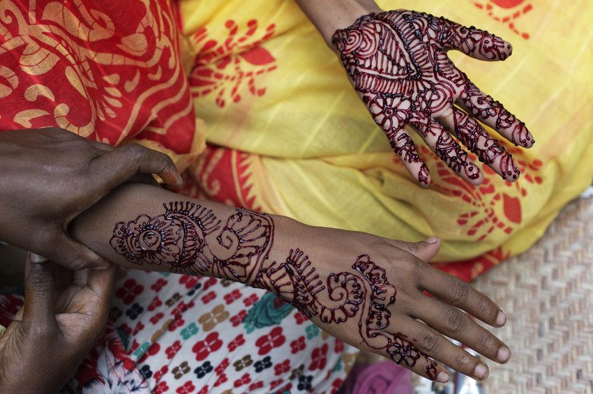 Bridal henna painted onto a young woman's hands.