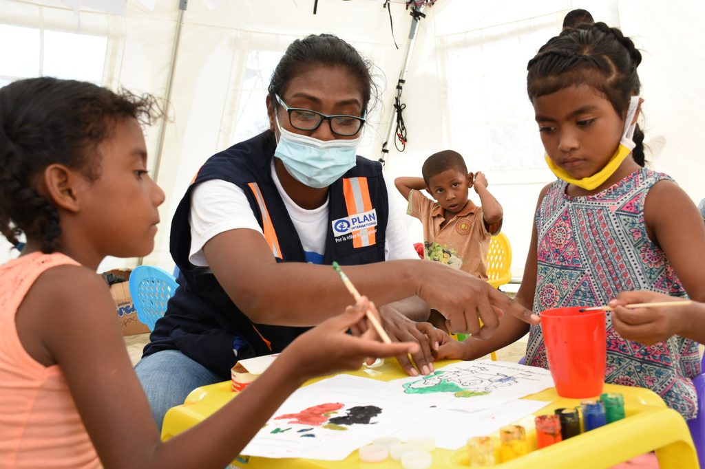 Children affected by Hurricane Iota paint pictures at a child-friendly space in Bilwi, Nicaragua. 