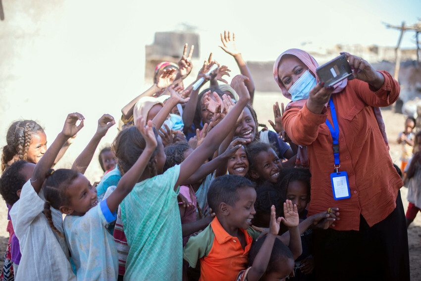 Nahid takes photos of displaced children at a literacy centre in Kassala State.  Photo credit: Plan International