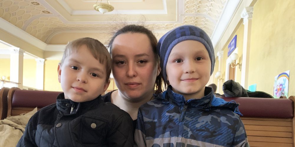 Lydia, 25, with her two children at Lviv train station