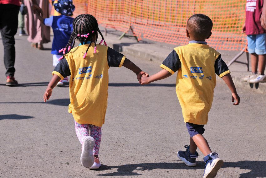 Young children hold hands in Ethiopia